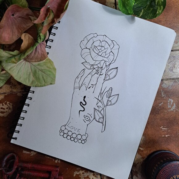 Traditional Tattoo style drawing of a hand holding onto a flower artwork - Picture 1 of 1